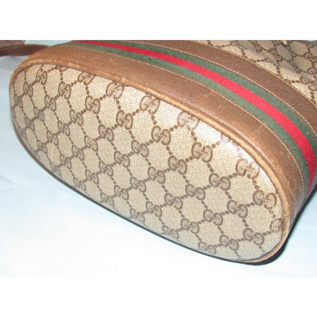 Gucci brown Guccissima print coated canvas & brown leather drawstring top Bucket Bag w red & green striped bottom