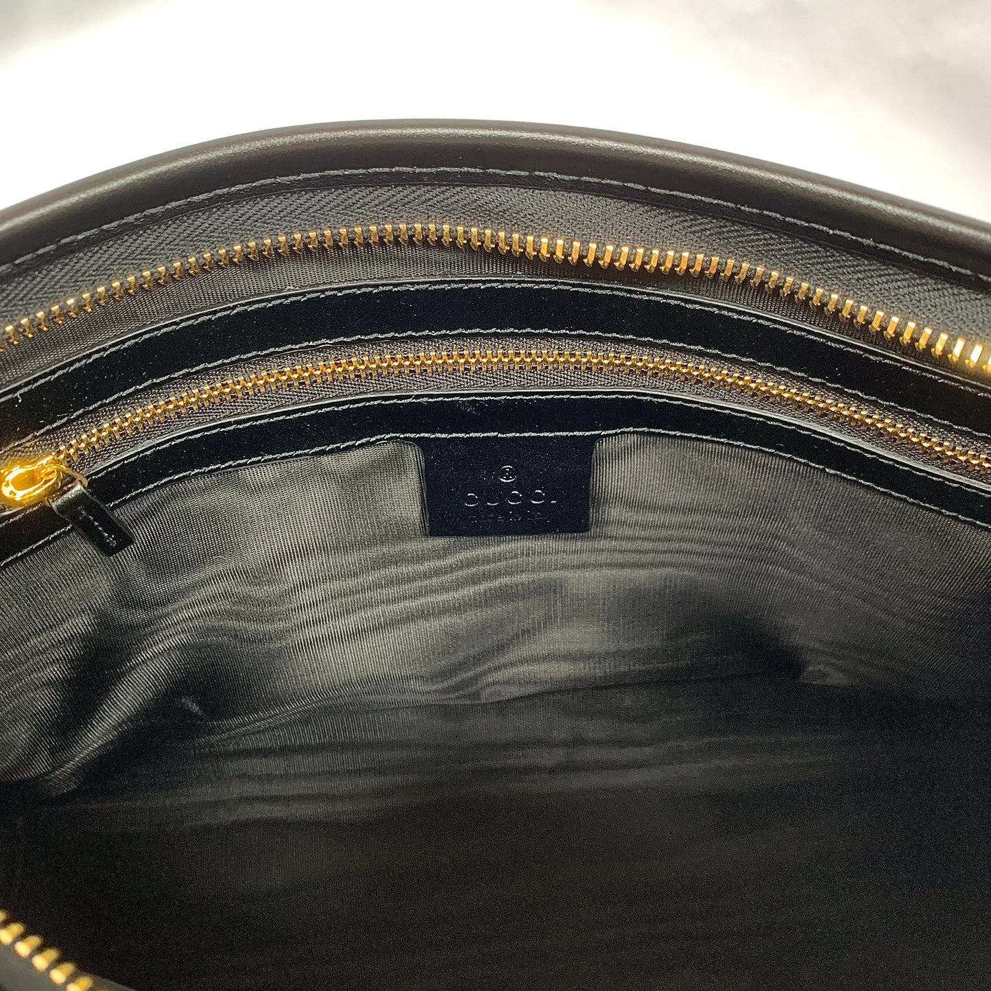 Gucci Metallic Print Logo Smooth Leather Clutch in Black