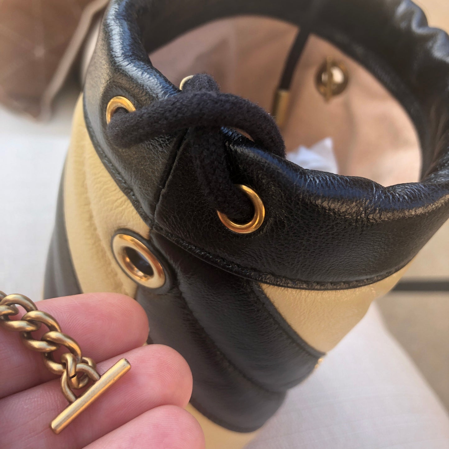 Gucci GG Marmont Bucket Bag in Black and Beige with Red Trim