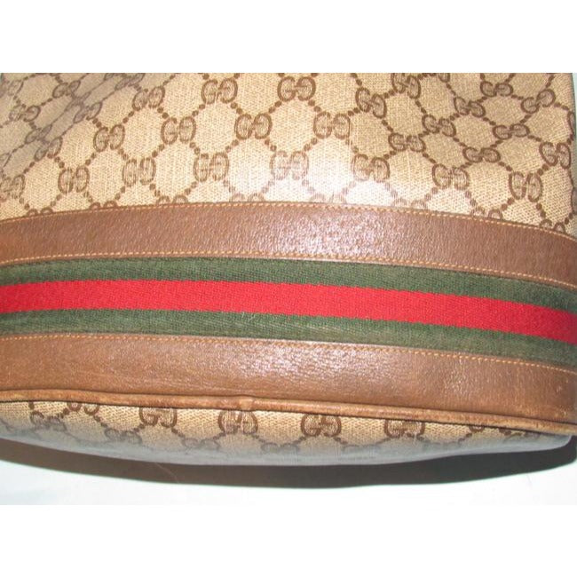 Gucci brown Guccissima print coated canvas & brown leather drawstring top Bucket Bag w red & green striped bottom