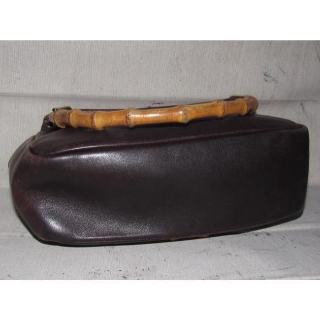 Gucci, mod look, supple brown leather satchel style bag with two bamboo handles & accents, gold tone hardware, a center zip closure