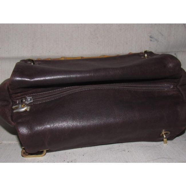 Gucci, mod look, supple brown leather satchel style bag with two bamboo handles & accents, gold tone hardware, a center zip closure