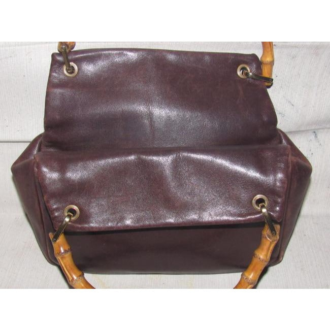 Gucci, mod look, supple brown leather satchel style bag with two bamboo handles & accents, gold tone hardware, a center zip closure