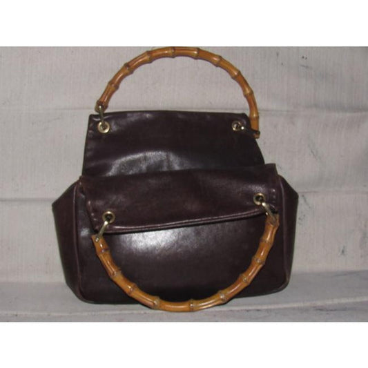 Gucci, mod look, supple brown leather satchel style bag with two bamboo handles & accents, gold tone hardware, a center zip closure